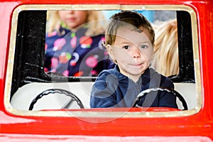 Close Up of a Boy on a Merry-Go-Round Car