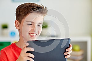 Close up of boy with tablet pc computer at home