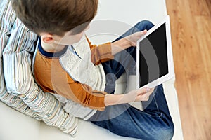 close up of boy with tablet pc computer at home