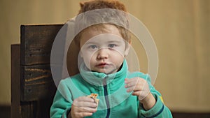 Close-up of a boy which eats a tasty pizza. Tasty pizza concept. Little boy having a slice of pizza. Hungry child taking