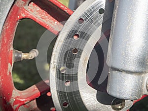 Close-up of the brake disc on the wheel of a scooter