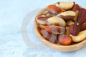 Close up of brasil nuts in a wooden plate