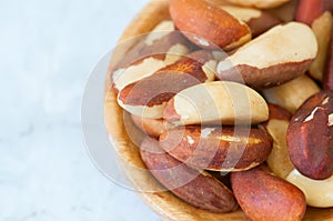 Close up of brasil nuts in a wooden plate