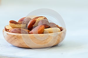 Close up of brasil nuts in a wooden plate