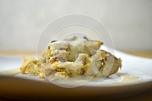 Close up bread butter pudding on white plate