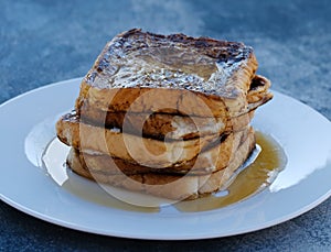 French toast stack on plate with syrup