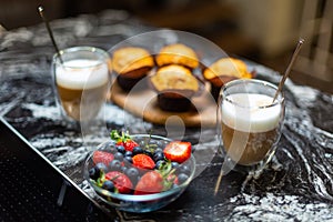 Close-up. Breakfast for two. Coffee latte with strawberry muffins.