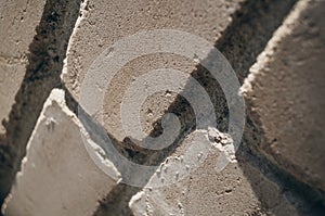 Close-up of the brick wall at an angle. Blurry areas of the frame, graininess.