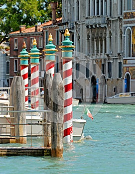 Close-up of bricole in a canal in Venice, Italy photo