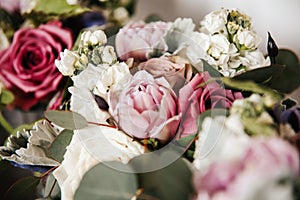 Close up of bridal wedding bouquet - pink peonies, rabbit ear plant, white hydrangea, purple lilies