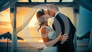 Close Up of Bride and Groom During an Outdoors Wedding Ceremony on an Ocean Beach at Sunset. Perfect