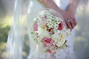 Close up of the bride`s hands holding a bouquet of flowers. Bridal bouquet, hold the wedding bouquet