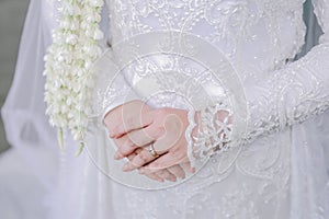 Close up of a brides hands with weding ring on finger