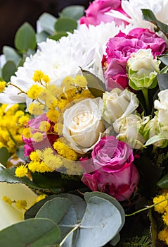 Close up of a bright colored floral arrangement consisting of different flowers.