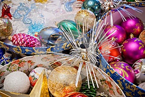 Close-up bright colorful Christmas decorations in open round boxes.