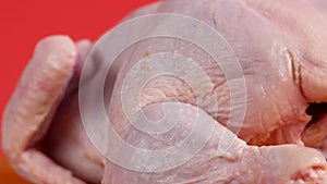 Close-up of a broiler chicken carcass rotates. Cooking dietary chicken meat. Raw fresh chicken is spinning. White meat close-up. S