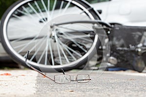 Close-up of broken glasses after collision with a biker and irresponsible car driver