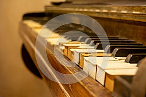 Close Up on Broken Old Piano Keys on Blurred Background