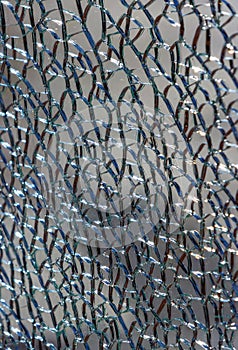 Close up of broken tempered glass background vertical view