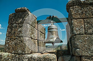 Close-up of bronze bells on top of stone brick wall