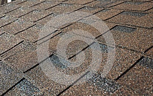 Close up on brown asphalt shingles roof. Roofing Construction