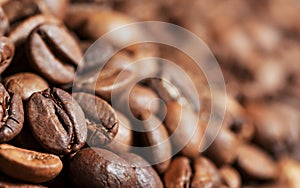 Close up brown and black roasted coffee beans or grains background