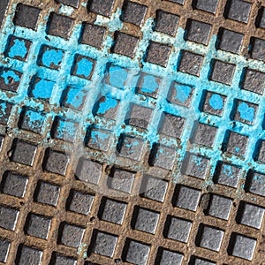 Close - up of a brown and blue manhole cover