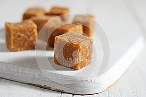 Close up brown cane sugar on white background