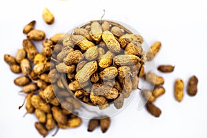 Close up of brown colored hamper having groundnuts or peanuts or moongaphalee or Arachis hypogaea or goober or monkey nut isolated