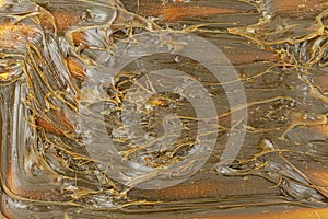 Close-Up of Brown-colored textured MPLR lubricating molybdenum disulfide grease.