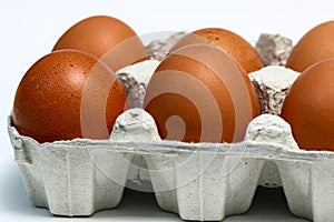 Close up of brown eggs in an egg box