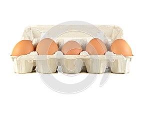 Close up of brown eggs in a egg tray. Chicken eggs. Fresh eggs on a white background