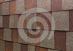 A close-up on brown and gray asphal roof shingles when choosing the right roof shingle color