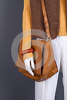 Close up brown leather handbag on mannequin.