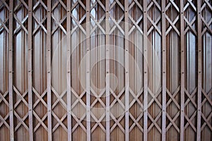 Close up brown metal grille sliding door.