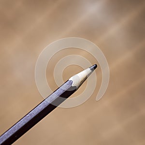 a close up of a brown pencil against a smooth background