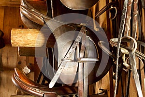 Close up of brown Saddles in a Tack Room