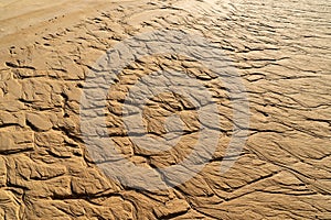 Close up of brown wave sand or rock pattern texture background on beach or desert. Top view. Outdoor