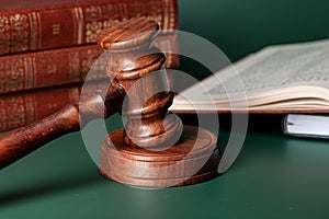 Close up of a brown wooden gavel and book