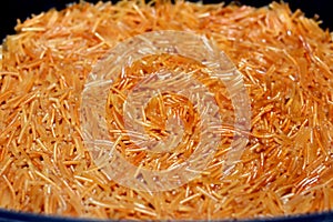 A close up of browned in Butter sweet Egyptian vermicelli cooked with water and sugar in a cooking pot