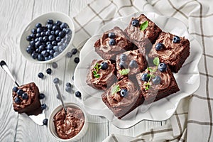 Close-up of brownies with berries on a cake stand