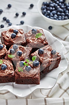 Close-up of brownies with berries on a cake stand