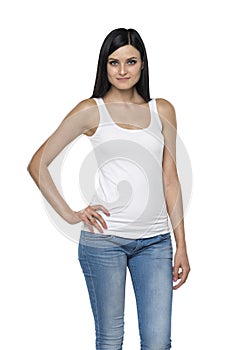 Close up of a brunette lady in a tank top and denims.