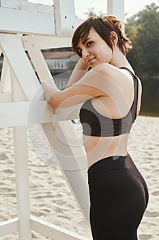 Close-up of brunette with short haircut near volleyball seat