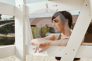 Close-up of brunette with short haircut near volleyball seat