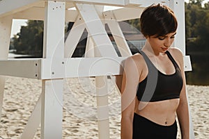 Close-up of brunette with short haircut under volleyball seat