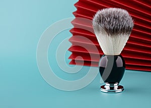 Close up of brush for shaving on a red and meant  background.