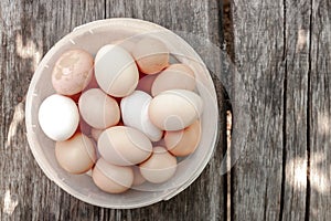 close up bucket with collection of hen eggs. flat lay at wooden background. agricultural hen eggs concept