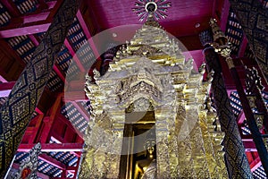 Close-up of Buddha image in golden pagoda at the main hall of Wat Prathat Lampang Luang, an ancient Buddhist temple in Lampang.