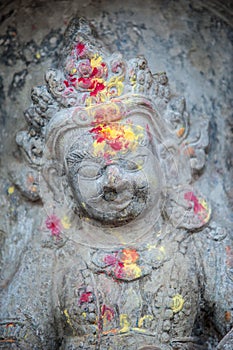 Close up buddhist statue Kathmandu Nepal. Close up of oblations of food and flowers to their gods on small statues , Kathmandu